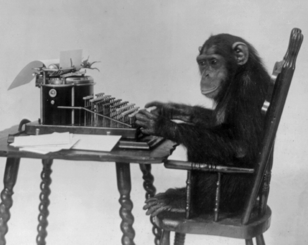 A chimpanzee seated at a typewriter